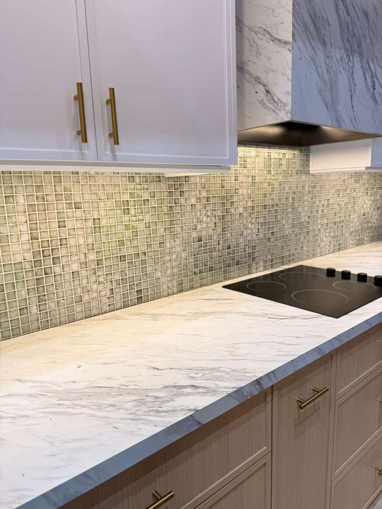 Kitchen glass mosaic tile backsplash with marble countertop and gold hardware — Sarasota backsplash installation