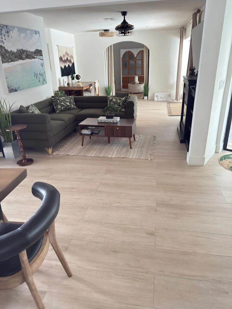 Open plan living room with wide plank LVP flooring throughout — luxury flooring installation in Sarasota home