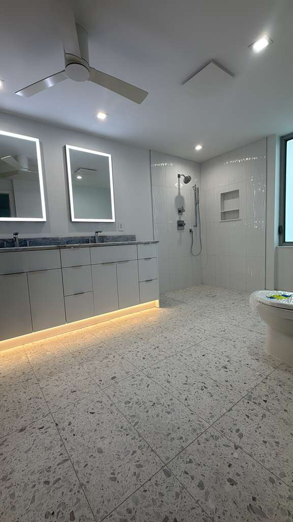 Modern terrazzo tile floor with walk-in shower — precision tile work in Sarasota home